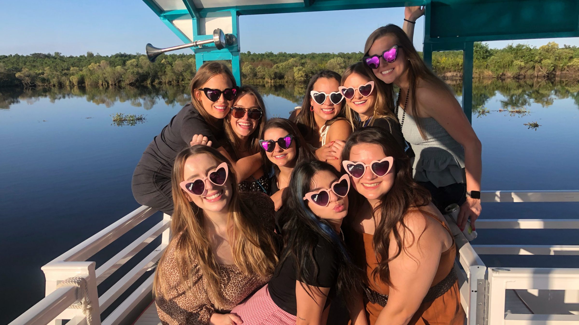 a woman posing in front of a body of water