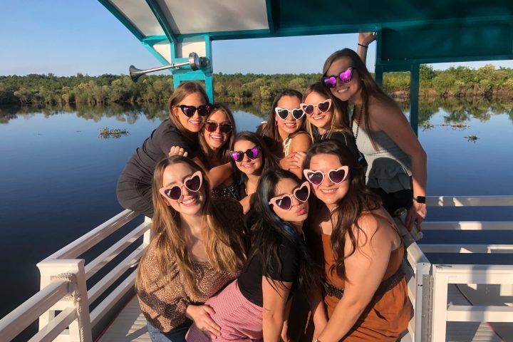 a woman posing in front of a body of water