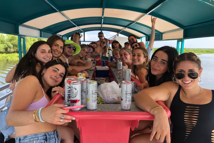 a group of people sitting at a table posing for the camera