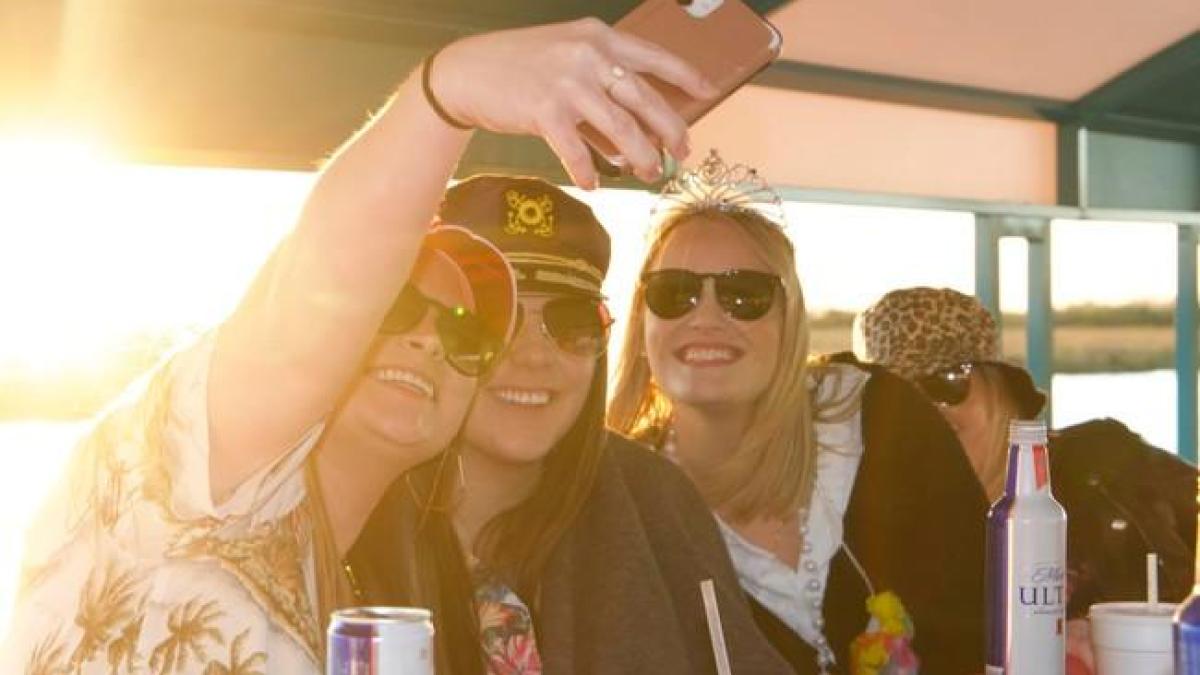 a woman sitting at a table with a cup of coffee